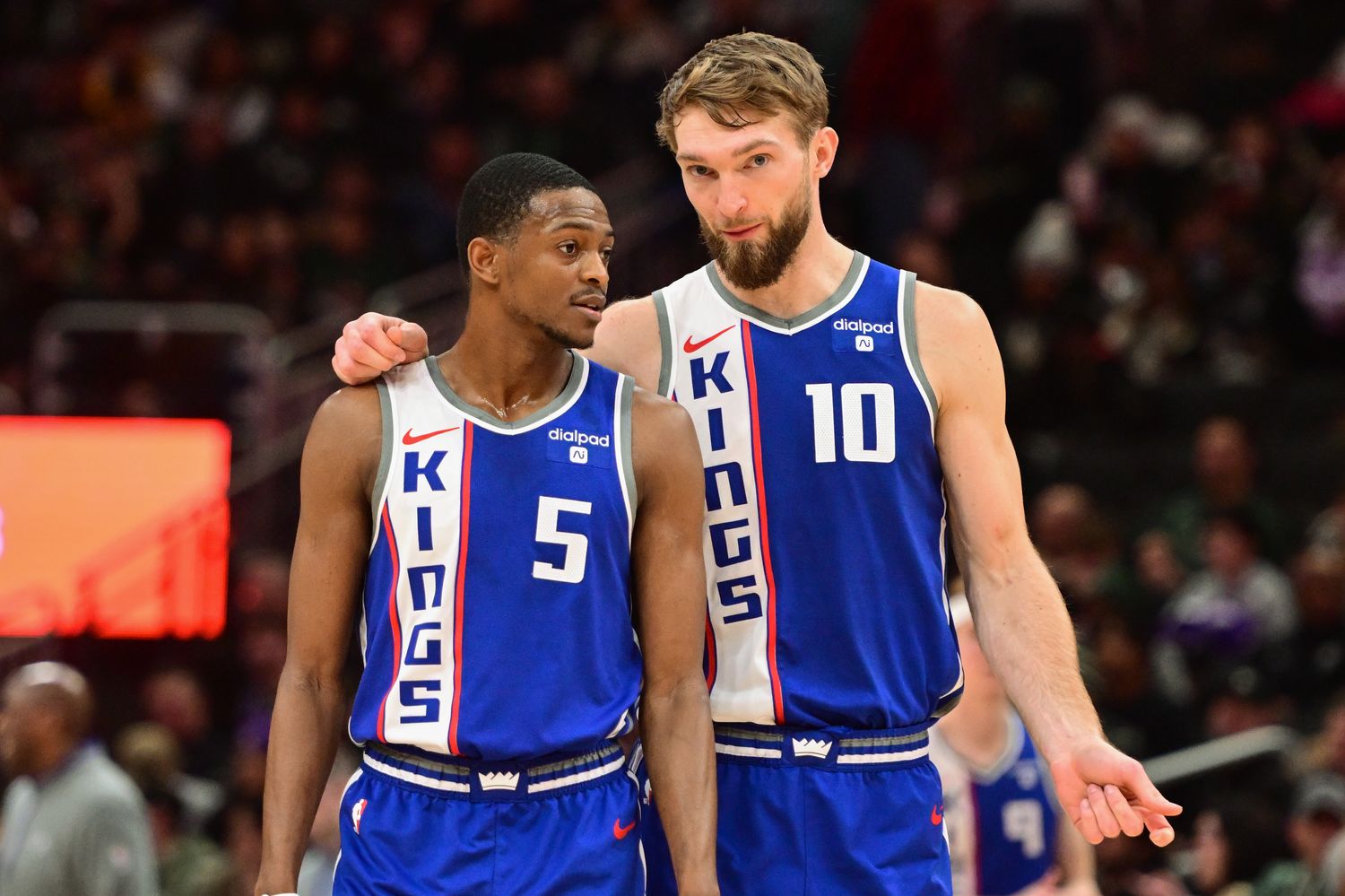 Jan 14, 2024; Milwaukee, Wisconsin, USA; Sacramento Kings guard De'Aaron Fox (5) and center Domantas Sabonis (10) talk during a timeout in the third quarter against the Milwaukee Bucks at Fiserv Forum. Mandatory Credit: Benny Sieu-USA TODAY Sports  